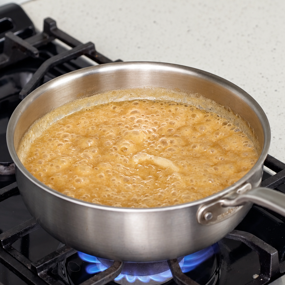 turkey gravy bubbling in silver sauce pot