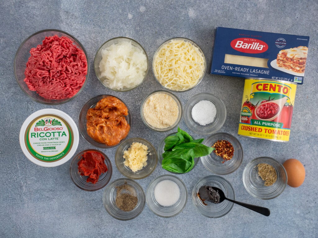 lasagna ingredients displayed on grey background