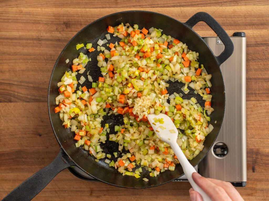 mirepoix simmering in black cast iron
