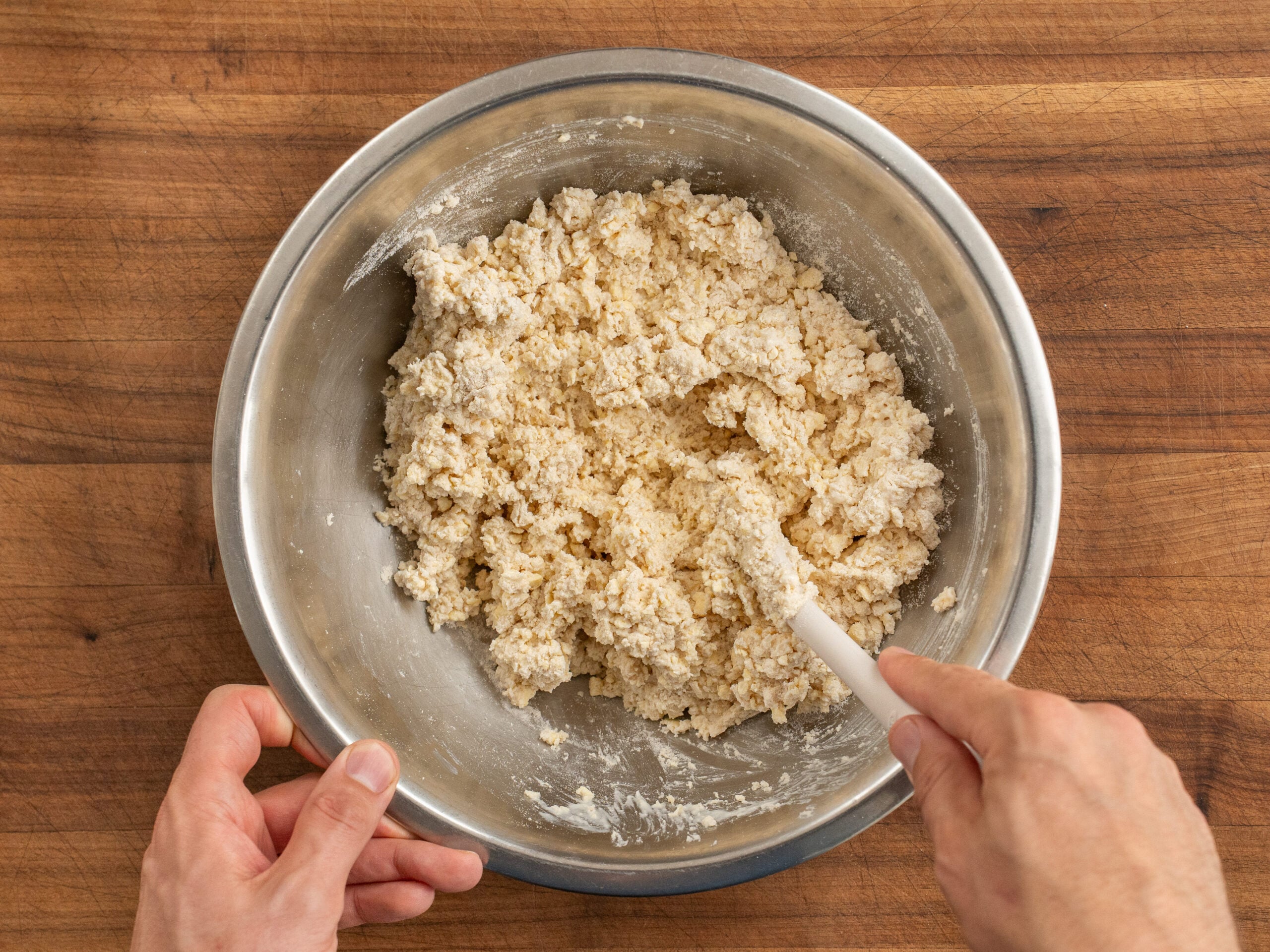 mixing biscuit dough with white spatula