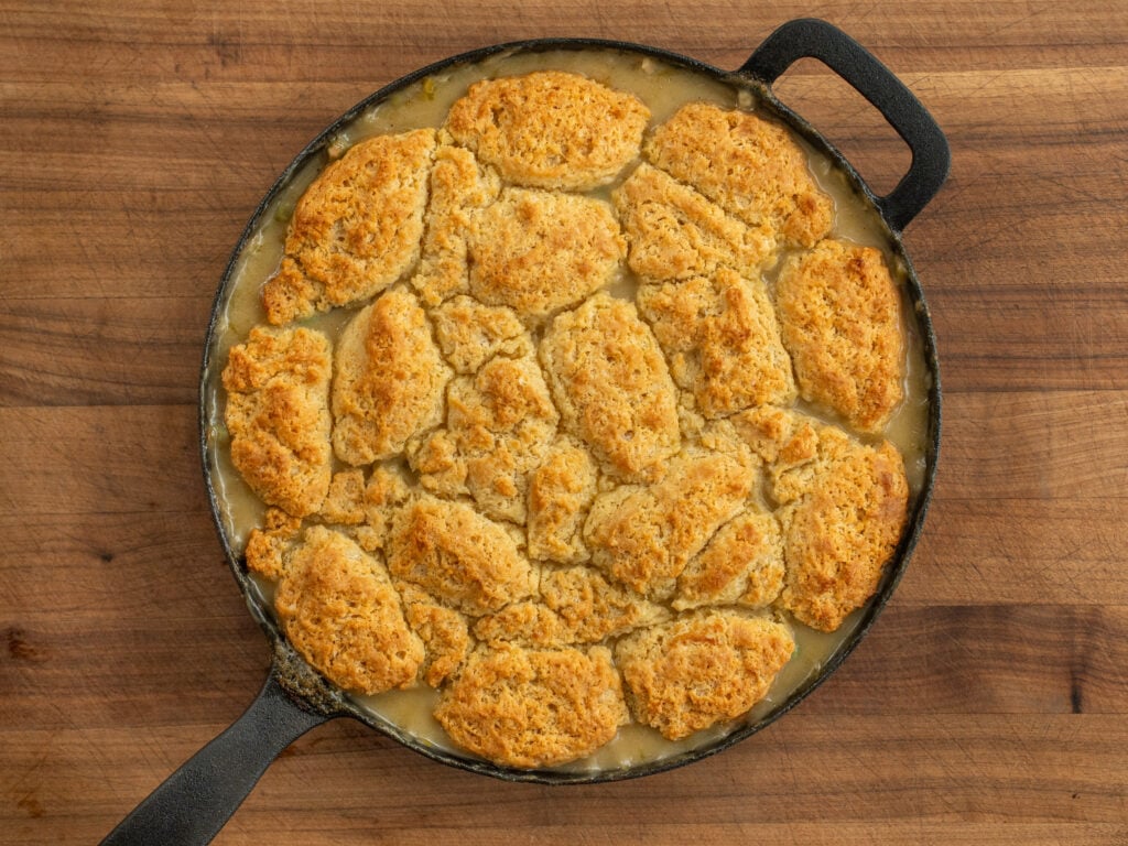 drop biscuit chicken pot pit on cutting board in cast iron pan