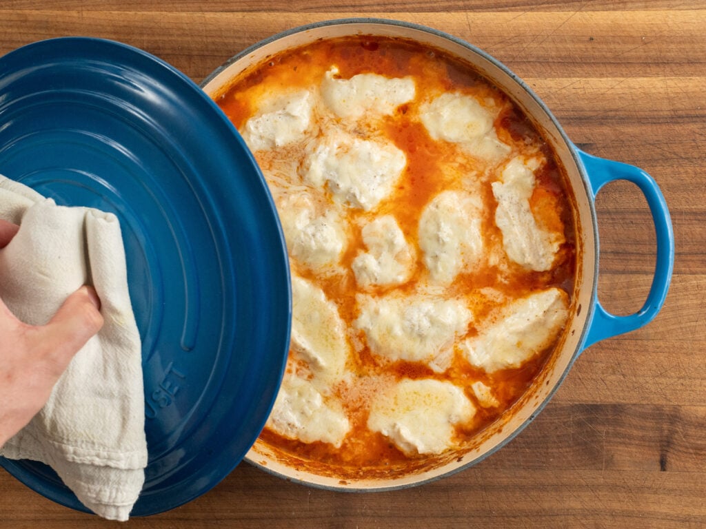 removing blue lid from partially baked one pot lasagna